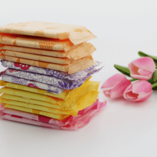Feminine hygiene products and flower on white background