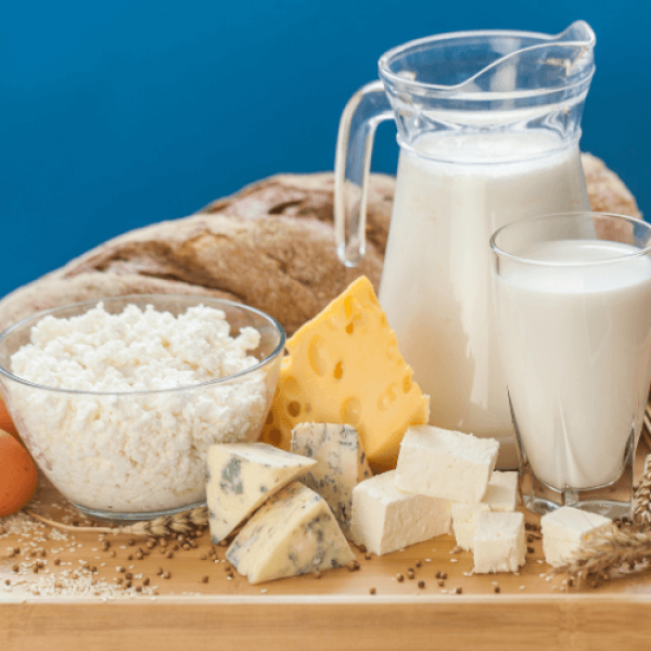 Photo of milk products - milk, yogurt and cheese - on blue background