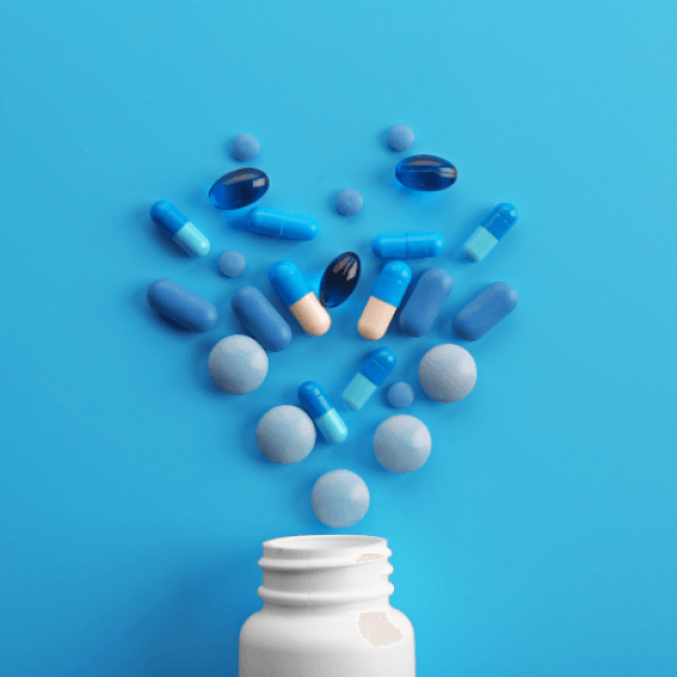 Pain medication and bottle on blue background