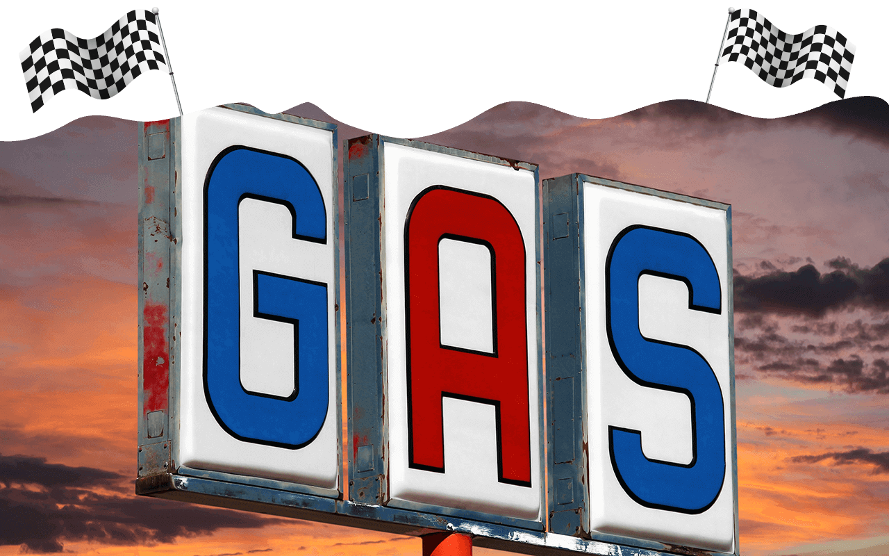 Gas sign with sunset in the background and checkered flags
