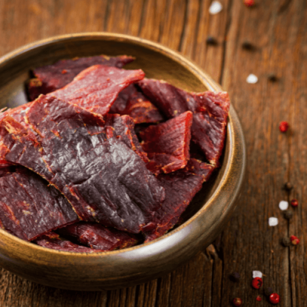 BBQ meat in a bowl on a wooden table