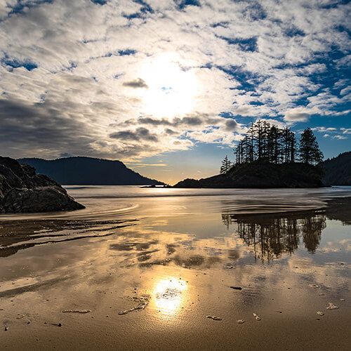 San Josef Bay white sandy beach photo with sunset in the background