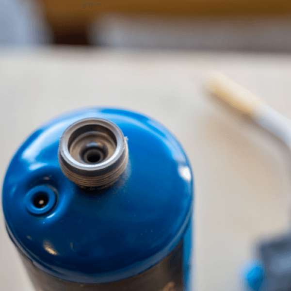 Blue propane tank on a table