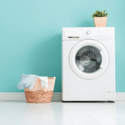 Laundry machine and laundry with blue wallpaper in the background